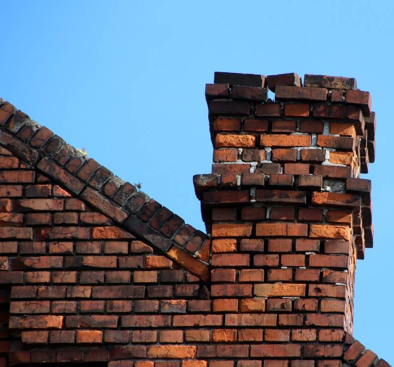 Damaged chimney on an Wheaton home showing cracks and missing mortar
